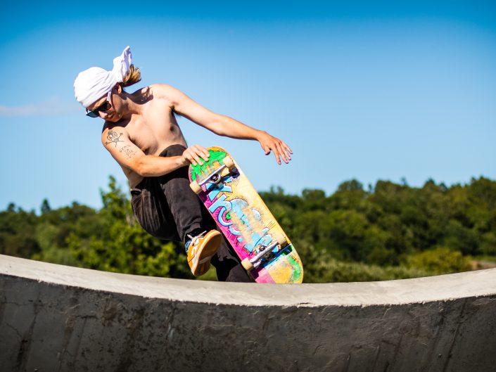 Skateboarder performing tricks in park.