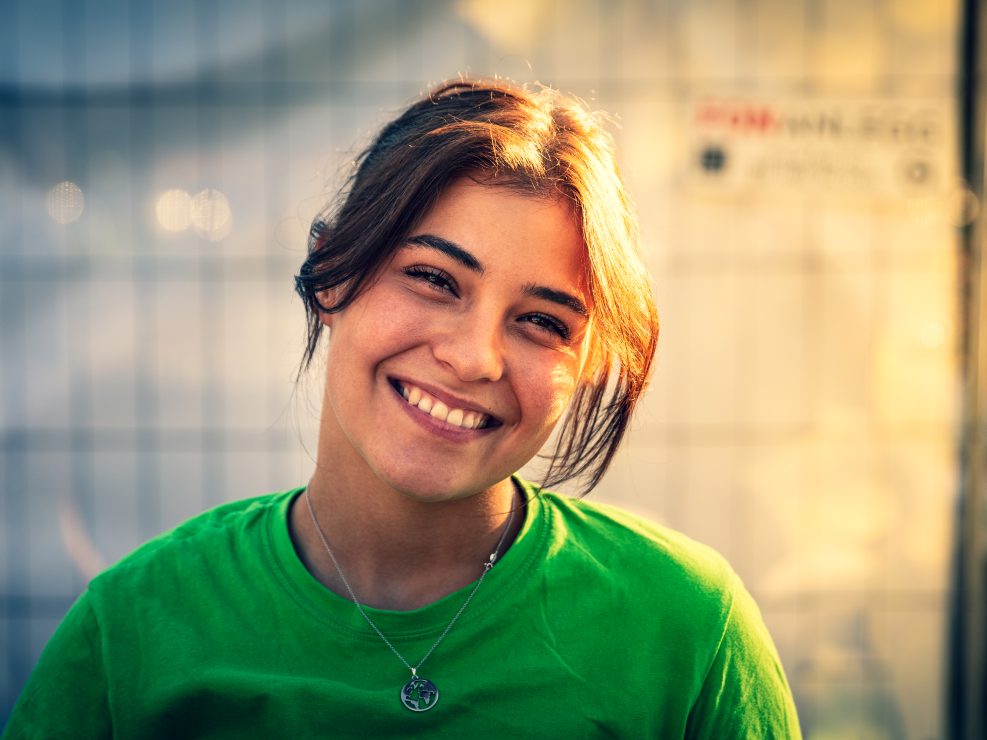 Person wearing green shirt outdoors.